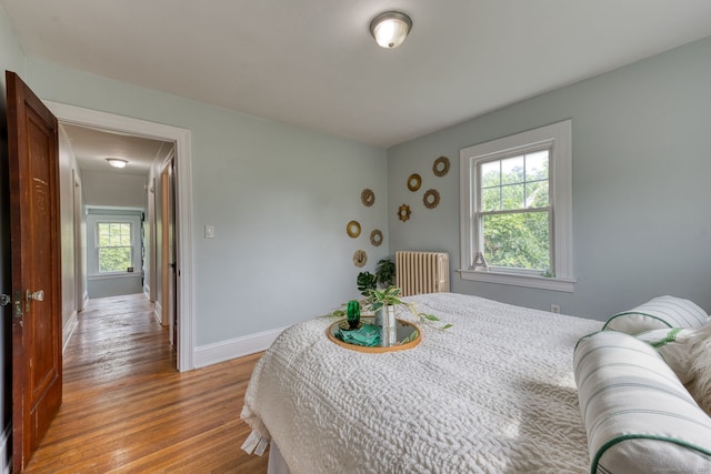 7 Ellsworth St, East Hartford, CT 06108 - bedroom featuring radiator heating unit, light wood finished floors, and attic access