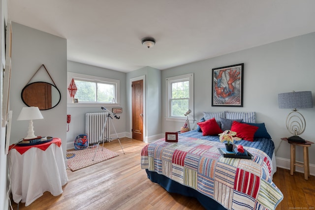 7 Ellsworth St, East Hartford, CT 06108 - bedroom featuring radiator, multiple windows, and wood finished floors