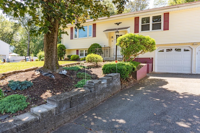 76 Brookview Rd, Windsor, CT 06095 - raised ranch featuring asphalt driveway and a garage