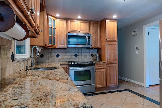 76 Brookview Rd, Windsor, CT 06095 - kitchen with appliances with stainless steel finishes, decorative backsplash, light stone counters, light tile patterned floors, and recessed lighting