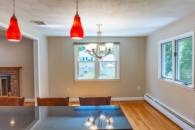 76 Brookview Rd, Windsor, CT 06095 - dining room with baseboard heating, healthy amount of natural light, wood finished floors, and a chandelier