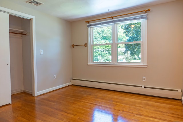 76 Brookview Rd, Windsor, CT 06095 - unfurnished bedroom featuring wood finished floors, a baseboard heating unit, and a closet