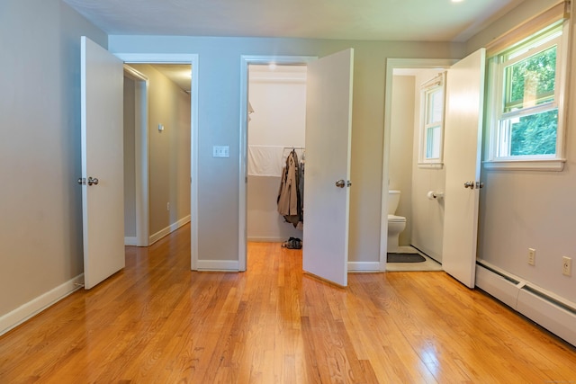 76 Brookview Rd, Windsor, CT 06095 - unfurnished bedroom featuring baseboard heating, a spacious closet, light wood-type flooring, and a closet