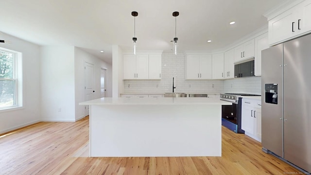 55A Moulthrop St, Ansonia, CT 06401 - kitchen featuring stainless steel appliances, light wood-style flooring, backsplash, light countertops, and white cabinets