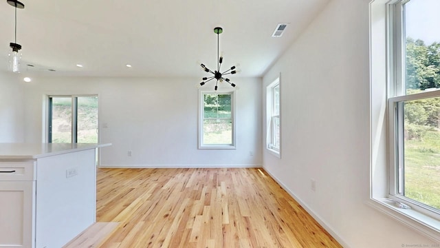55A Moulthrop St, Ansonia, CT 06401 - unfurnished dining area featuring light wood-style floors, recessed lighting, and a chandelier