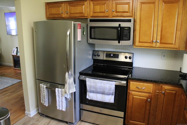 66 Long Meadow Hill Rd Unit 1, Brookfield, CT 06804 - kitchen with stainless steel appliances, backsplash, light wood-type flooring, and brown cabinets