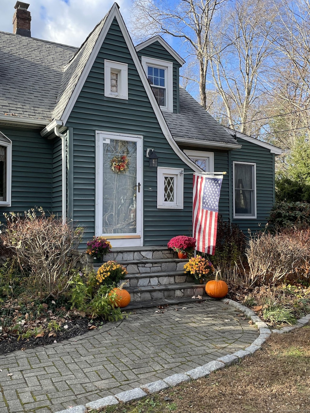 101 Shadduck Rd, Middlebury, CT 06762 - view of front of home featuring a shingled roof, a chimney, and a patio area