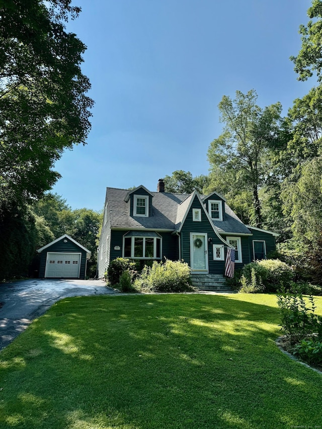 101 Shadduck Rd, Middlebury, CT 06762 - view of front of house with a garage, an outbuilding, asphalt driveway, a chimney, and a front lawn