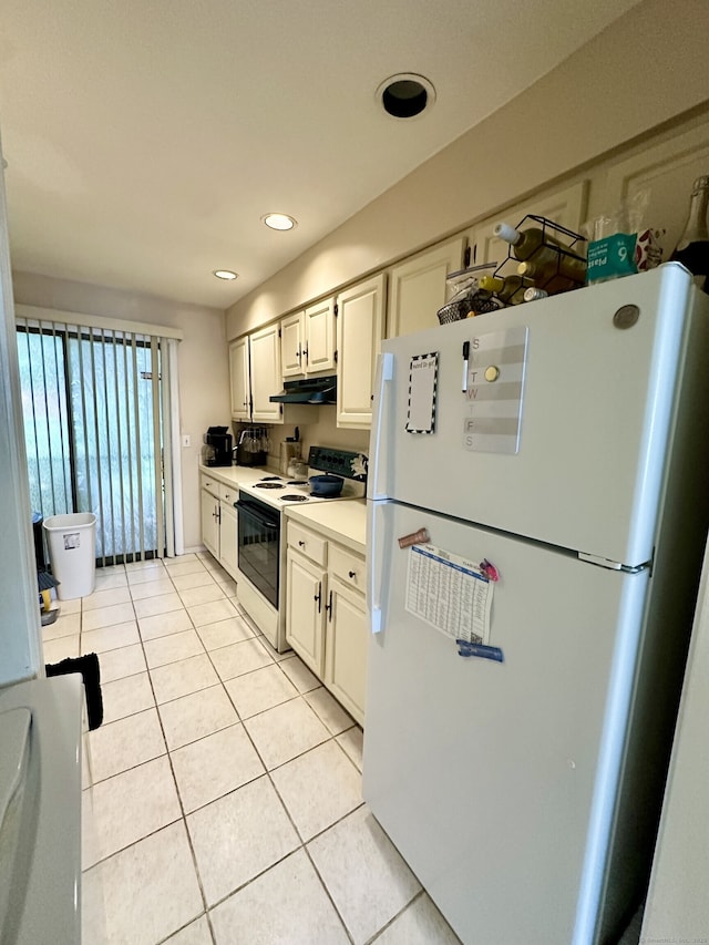 409 Glendale Ave Unit C2, Bridgeport, CT 06606 - kitchen with freestanding refrigerator, electric range, under cabinet range hood, light tile patterned flooring, and light countertops