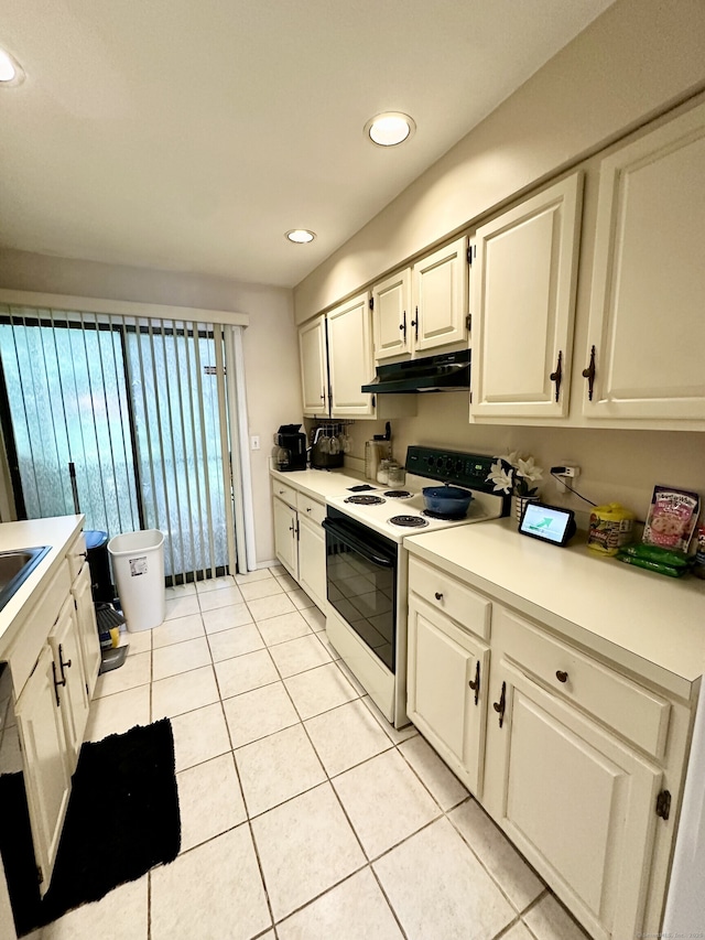 409 Glendale Ave Unit C2, Bridgeport, CT 06606 - kitchen with electric range oven, under cabinet range hood, white cabinetry, light tile patterned flooring, and light countertops
