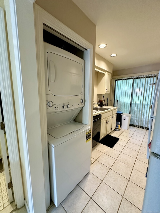 409 Glendale Ave Unit C2, Bridgeport, CT 06606 - laundry room with stacked washer and clothes dryer, light tile patterned floors, and recessed lighting