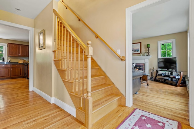 11 Acorn Dr, East Haddam, CT 06423 - stairs with a lit fireplace and wood finished floors