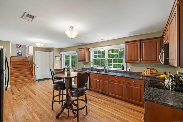 11 Acorn Dr, East Haddam, CT 06423 - kitchen featuring light wood-style flooring, appliances with stainless steel finishes, pendant lighting, and brown cabinetry