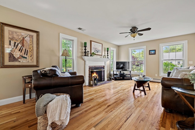 11 Acorn Dr, East Haddam, CT 06423 - living area featuring ceiling fan, wood finished floors, a tiled fireplace, and baseboard heating