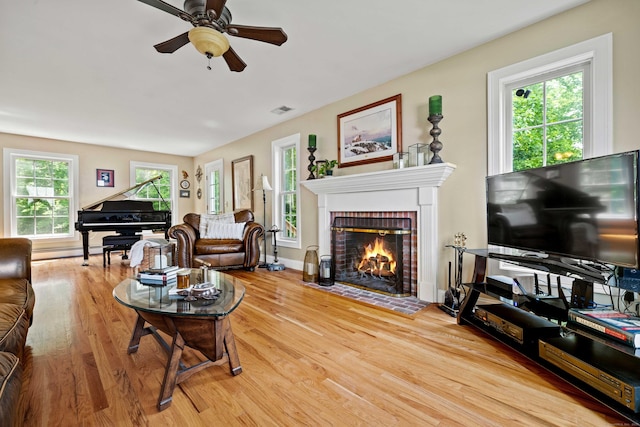 11 Acorn Dr, East Haddam, CT 06423 - living area featuring light wood-style floors, a ceiling fan, a brick fireplace, and a baseboard radiator