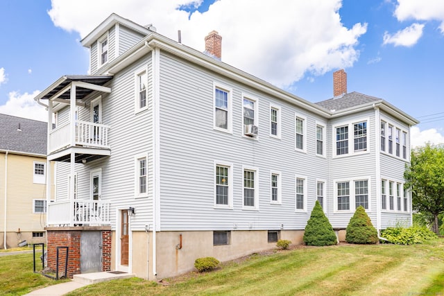 205 Wolcott Hill Rd, Wethersfield, CT 06109 - view of side of property featuring a chimney, a lawn, cooling unit, and a balcony