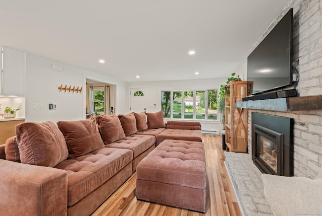 12 Warner Rd, East Haddam, CT 06423 - living room featuring a large fireplace, light wood-type flooring, plenty of natural light, a baseboard heating unit, and recessed lighting