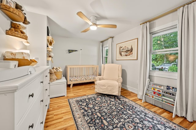 12 Warner Rd, East Haddam, CT 06423 - bedroom featuring light wood finished floors, a crib, and ceiling fan