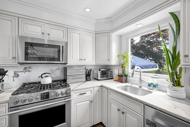 423 Whitfield St, Guilford, CT 06437 - kitchen featuring stainless steel appliances, white cabinets, backsplash, light stone countertops, and recessed lighting