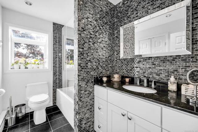 423 Whitfield St, Guilford, CT 06437 - bathroom featuring vanity, tile patterned floors, tile walls, decorative backsplash, and tub / shower combination
