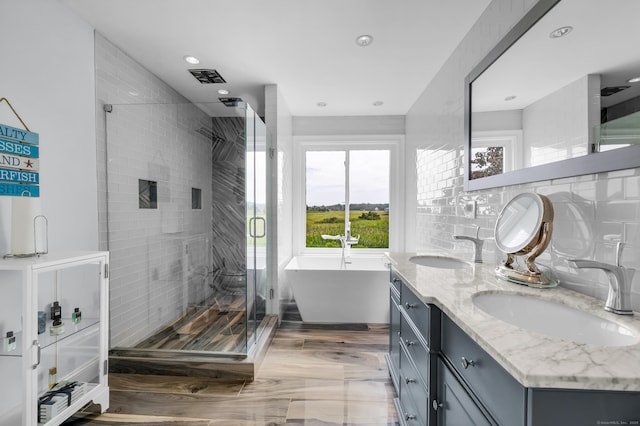 423 Whitfield St, Guilford, CT 06437 - full bath with a stall shower, double vanity, a soaking tub, recessed lighting, and tasteful backsplash