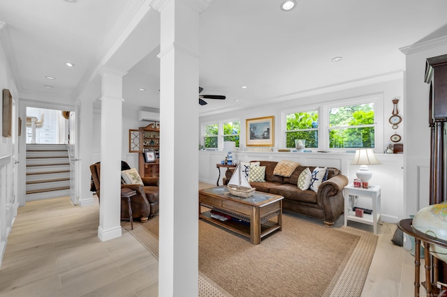 423 Whitfield St, Guilford, CT 06437 - living area with decorative columns, a wall mounted AC, crown molding, a ceiling fan, and light wood-style floors