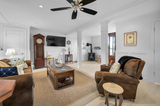 423 Whitfield St, Guilford, CT 06437 - living area featuring a wood stove, a ceiling fan, ornamental molding, decorative columns, and recessed lighting