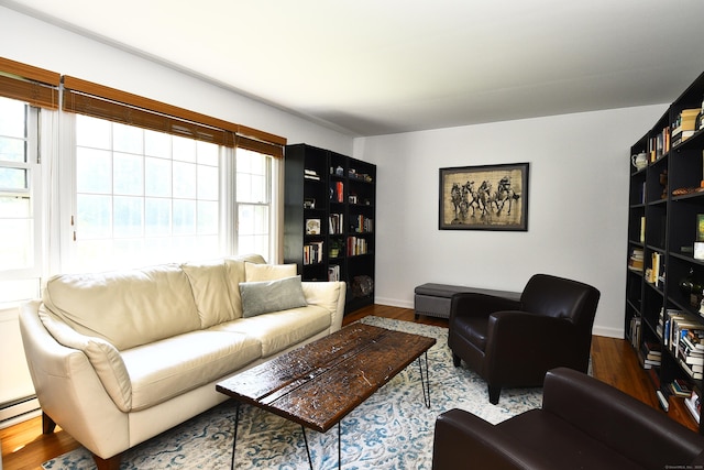 84 Parade Hill Rd Unit 84, New Canaan, CT 06840 - living area featuring healthy amount of natural light, wood finished floors, and a baseboard heating unit