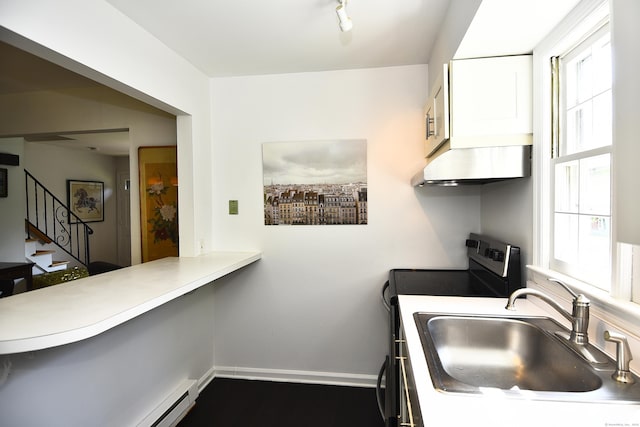 84 Parade Hill Rd Unit 84, New Canaan, CT 06840 - kitchen featuring range with electric stovetop, exhaust hood, white cabinets, a baseboard radiator, and light countertops