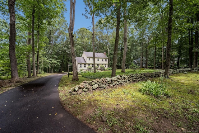 310 Opening Hill Rd, Madison, CT 06443 - view of front facade featuring a chimney, asphalt driveway, and a forest view