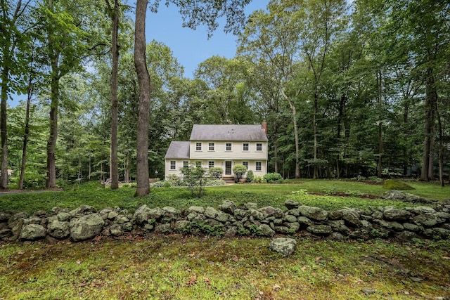 310 Opening Hill Rd, Madison, CT 06443 - view of front of house featuring a chimney, a front lawn, and a forest view
