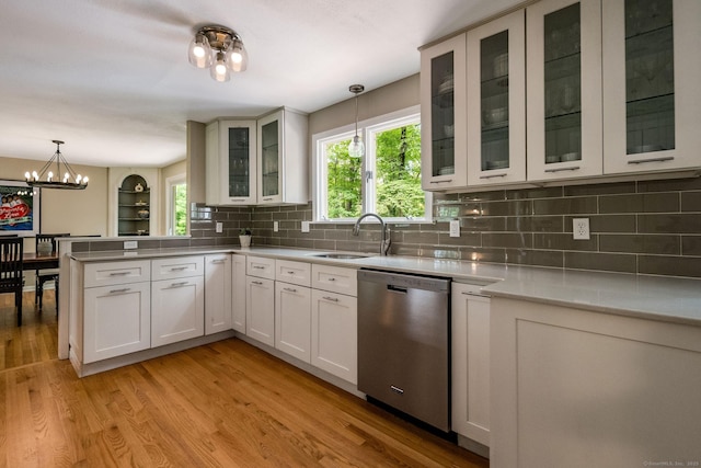 310 Opening Hill Rd, Madison, CT 06443 - kitchen featuring dishwasher, a chandelier, a peninsula, decorative backsplash, and pendant lighting