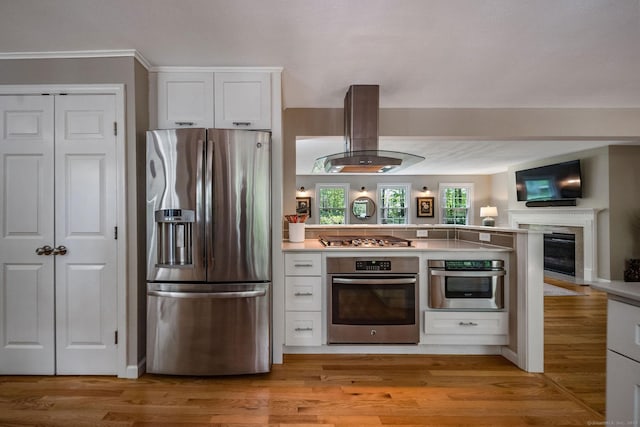 310 Opening Hill Rd, Madison, CT 06443 - kitchen featuring stainless steel appliances, island range hood, white cabinetry, a peninsula, and open floor plan