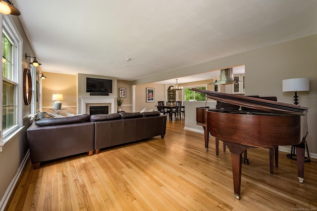 310 Opening Hill Rd, Madison, CT 06443 - living area featuring light wood finished floors, a fireplace, and a chandelier