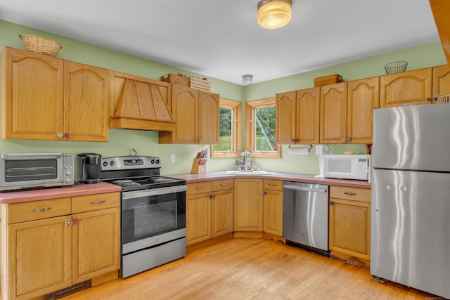 4 Overlook Dr, North Branford, CT 06471 - kitchen with appliances with stainless steel finishes, custom exhaust hood, light wood-type flooring, and light countertops