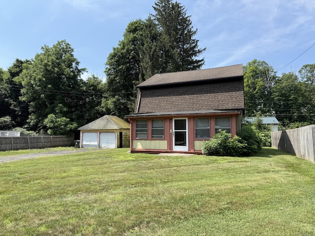 20 Greystone St, Windham, CT 06226 - view of front of home featuring a detached garage, a shingled roof, and an outbuilding