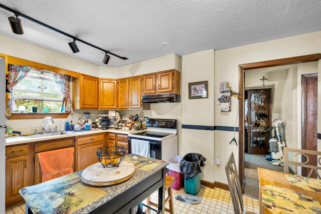 678 Colonel Ledyard Hwy, Ledyard, CT 06339 - kitchen with white electric stove, under cabinet range hood, rail lighting, a textured ceiling, and light countertops