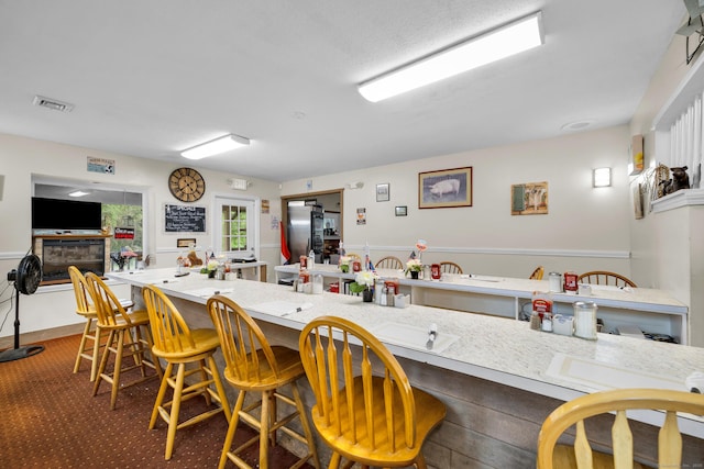 678 Colonel Ledyard Hwy, Ledyard, CT 06339 - kitchen featuring freestanding refrigerator, light countertops, and a breakfast bar area