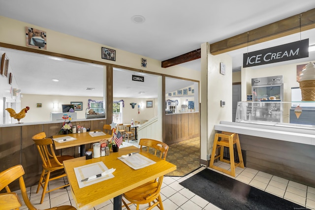 678 Colonel Ledyard Hwy, Ledyard, CT 06339 - tiled dining space with a wainscoted wall, beamed ceiling, and wooden walls
