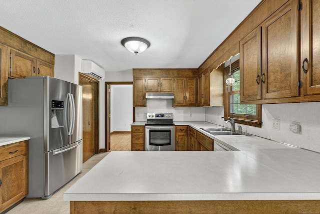 16 Eagle Ridge Dr, Ledyard, CT 06335 - kitchen featuring appliances with stainless steel finishes, a wall unit AC, light countertops, and a textured ceiling