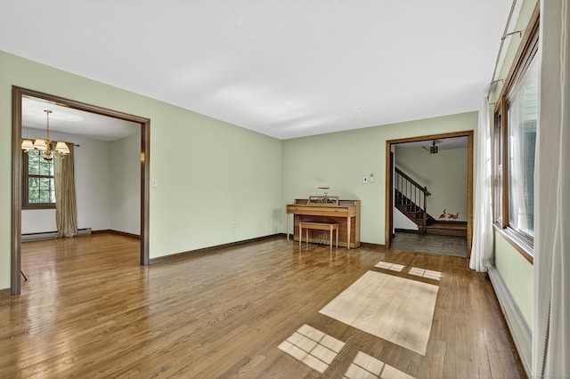 16 Eagle Ridge Dr, Ledyard, CT 06335 - unfurnished room with stairway, a chandelier, wood finished floors, and baseboard heating