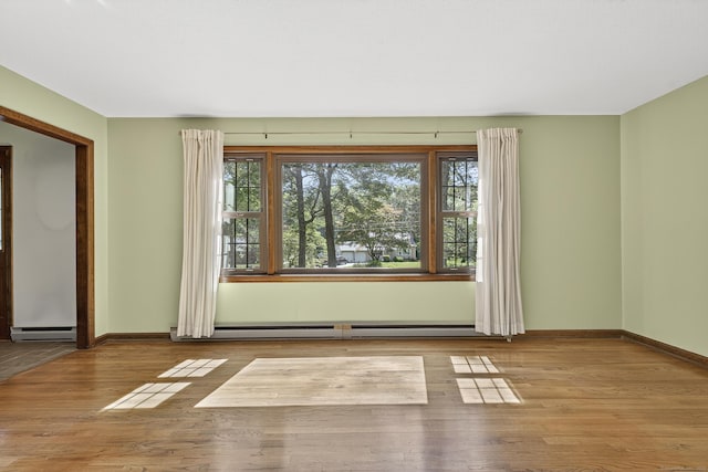 16 Eagle Ridge Dr, Ledyard, CT 06335 - spare room featuring a baseboard radiator, healthy amount of natural light, baseboard heating, and wood finished floors