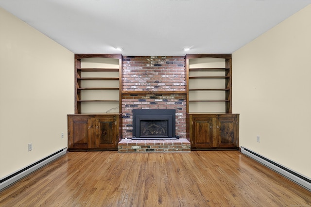 16 Eagle Ridge Dr, Ledyard, CT 06335 - unfurnished living room with a baseboard radiator, wood finished floors, and a fireplace