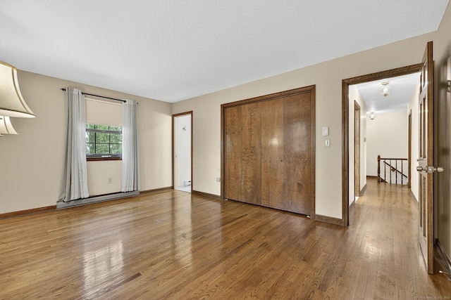 16 Eagle Ridge Dr, Ledyard, CT 06335 - unfurnished bedroom with wood finished floors, a baseboard radiator, and a closet