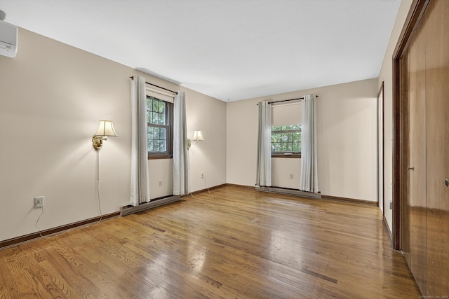 16 Eagle Ridge Dr, Ledyard, CT 06335 - spare room with healthy amount of natural light, wood finished floors, and a baseboard heating unit