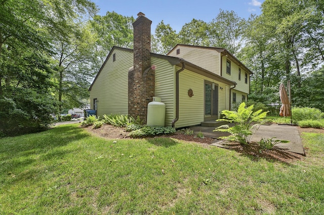 16 Eagle Ridge Dr, Ledyard, CT 06335 - view of home's exterior with a yard and a chimney