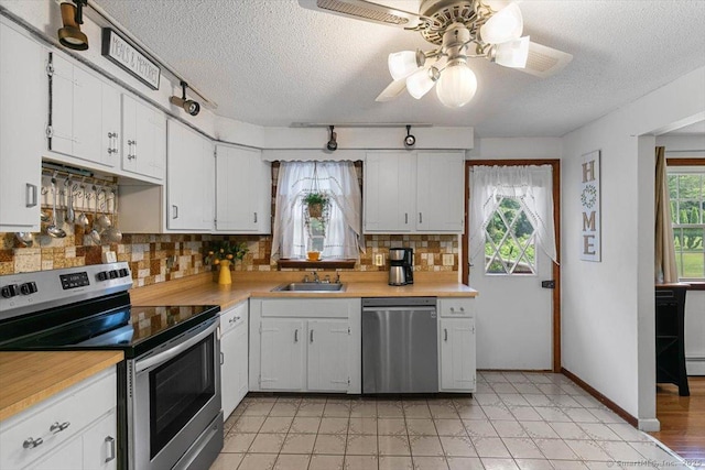 822 New Haven Ave, Milford, CT 06460 - kitchen featuring appliances with stainless steel finishes, light countertops, tasteful backsplash, and a textured ceiling
