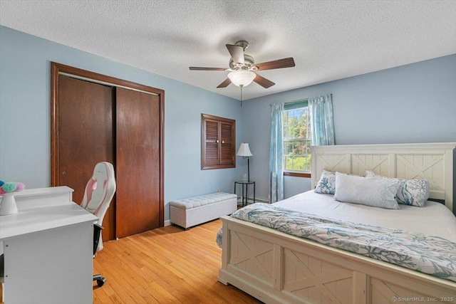 822 New Haven Ave, Milford, CT 06460 - bedroom featuring a closet, light wood-style flooring, a textured ceiling, and ceiling fan