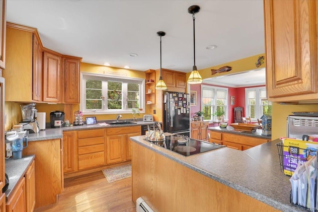100 Adams Rd, Bloomfield, CT 06002 - kitchen featuring black appliances, light wood-style floors, pendant lighting, a peninsula, and brown cabinets