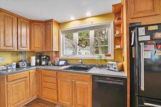100 Adams Rd, Bloomfield, CT 06002 - kitchen with freestanding refrigerator, black dishwasher, wood finished floors, and brown cabinets